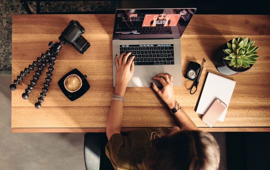 person editing video at desk