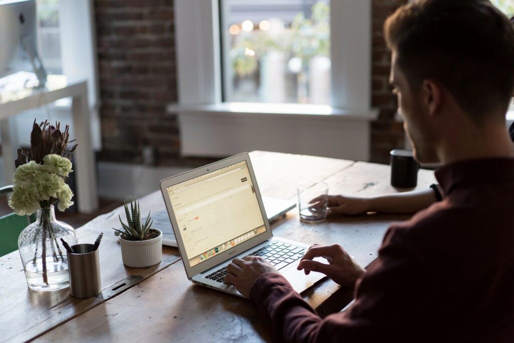 person looking at laptop from home office